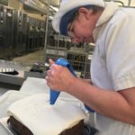 Patricia Hopkins decorating a cake