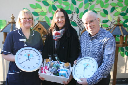 Photo of Cathie Alcock, Jane Walton and Andy Storey with the bird tables and holding the clocks. JPEG
