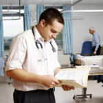 A doctor consulting a patient's notes